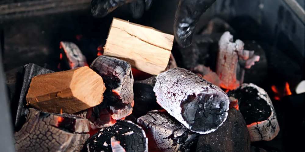 Meat smoking wood - charcoal with wood on fire