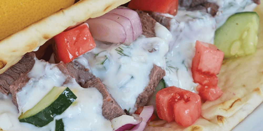 how to serve meat gyros - in sauce, closeup look